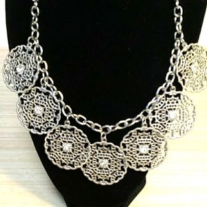 Silver tone medallion and rhinestone necklace